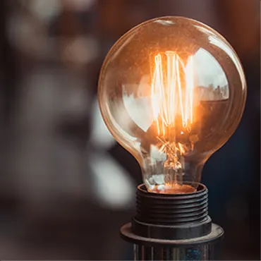 A light bulb is lit up in a dark room